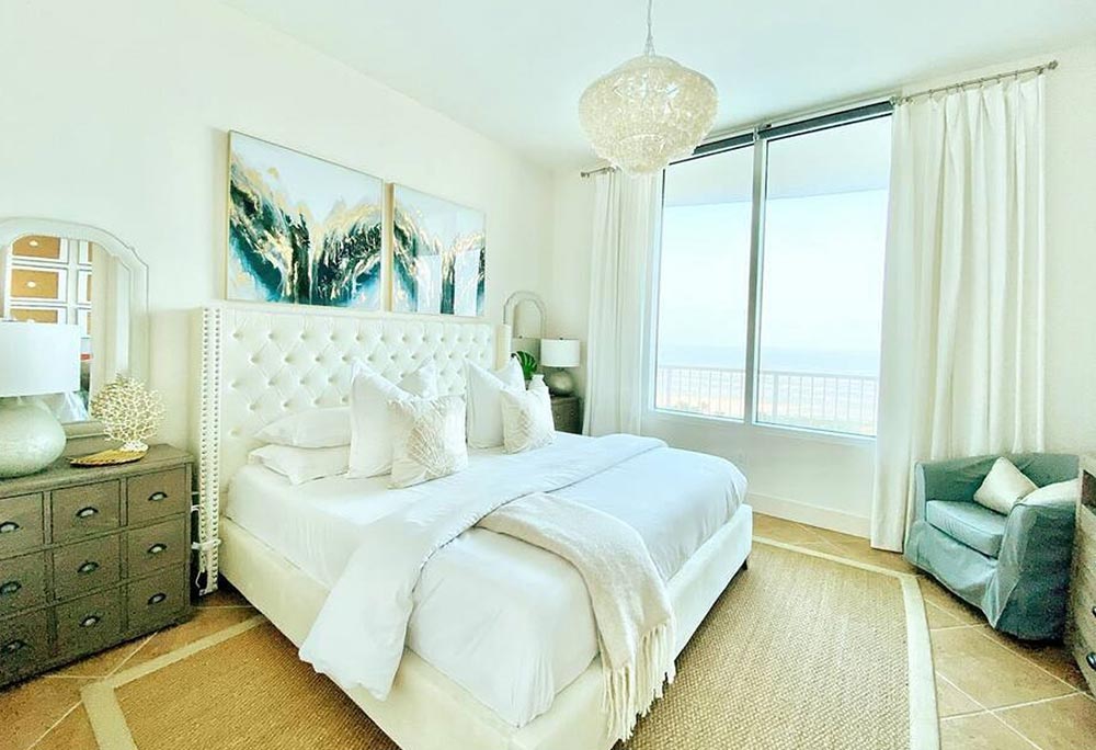 Guest bedroom with two beds and coastal decor at Casa Cova, South Padre Island